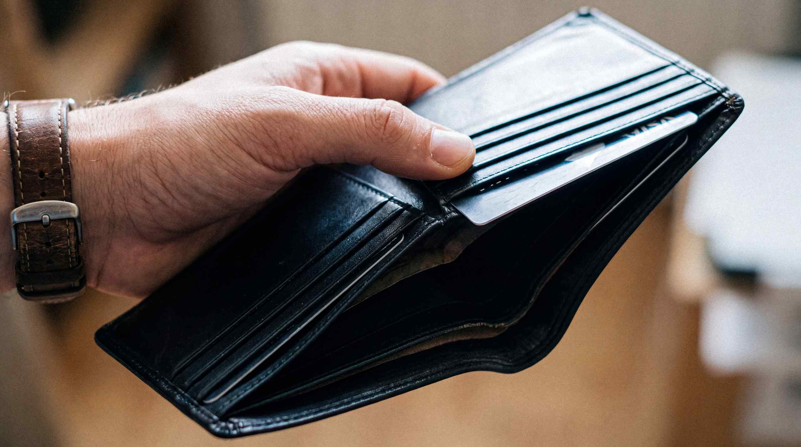 A nearly empty wallet with zero cash and a single credit card.
